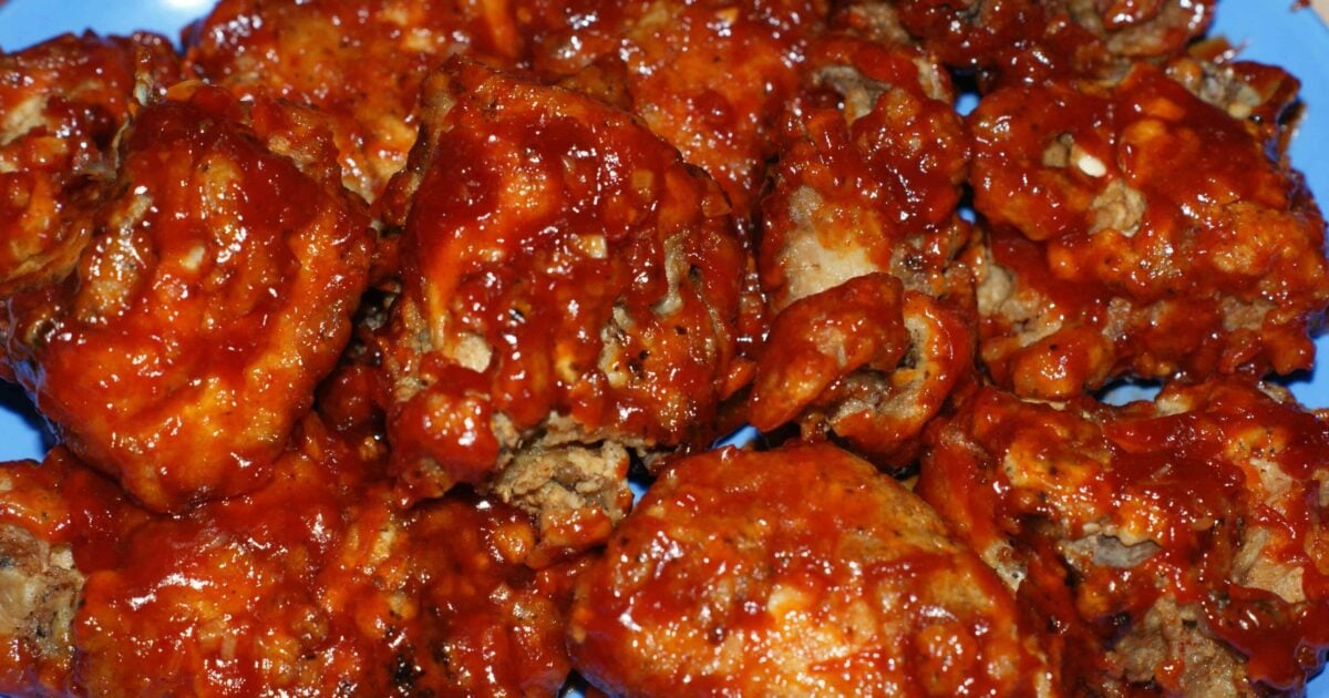 Homemade yangnyeom tongdak Korean seasoned fried chicken pieces glazed in glossy sweet spicy sauce