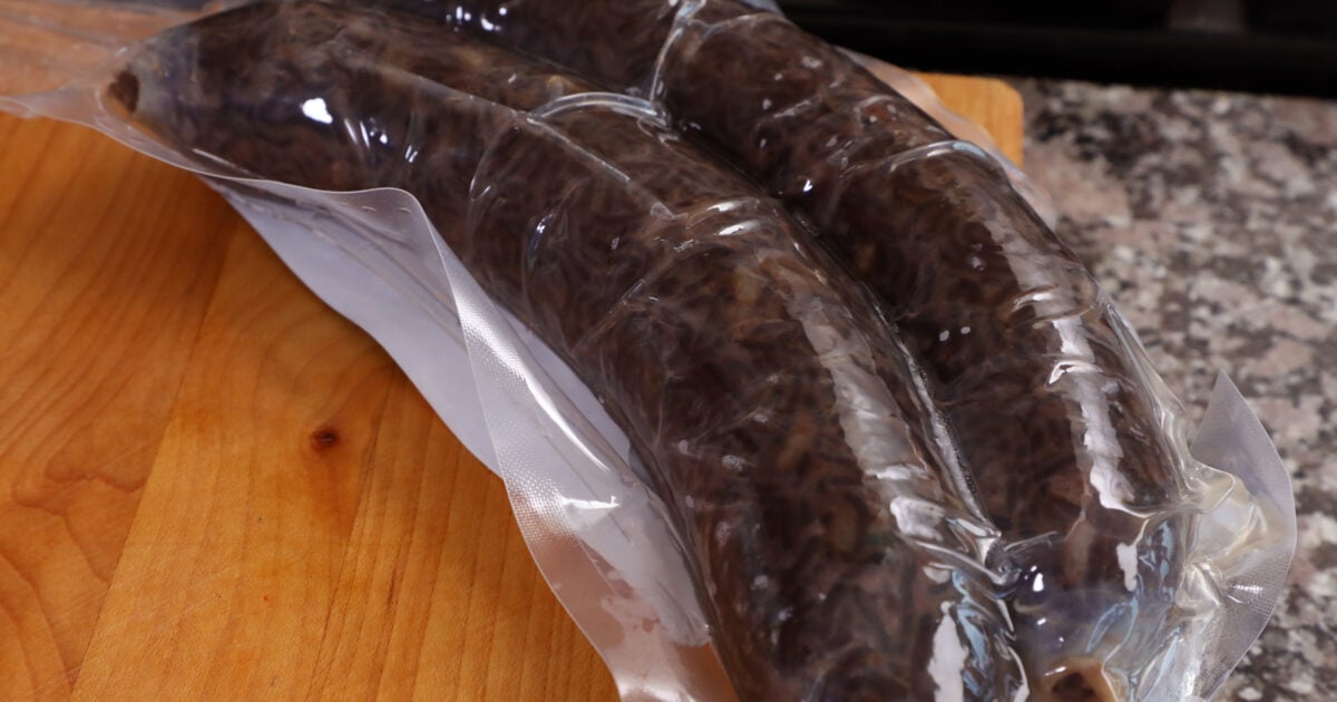 Freshly boiled Korean sundae blood sausage cooling on a plate at a Korean street market