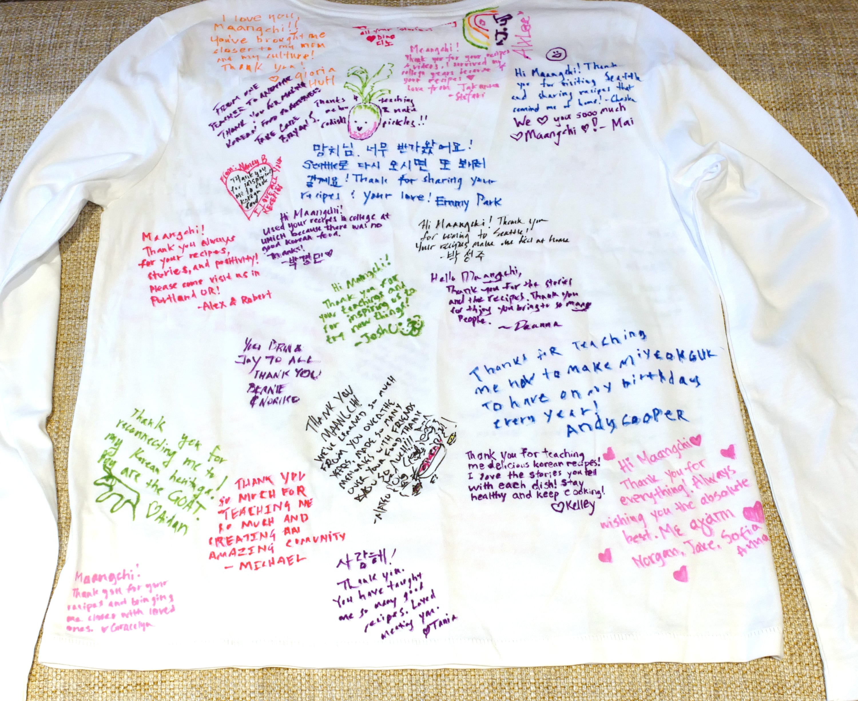 Back of the shirt with messages and drawings from meetup guests