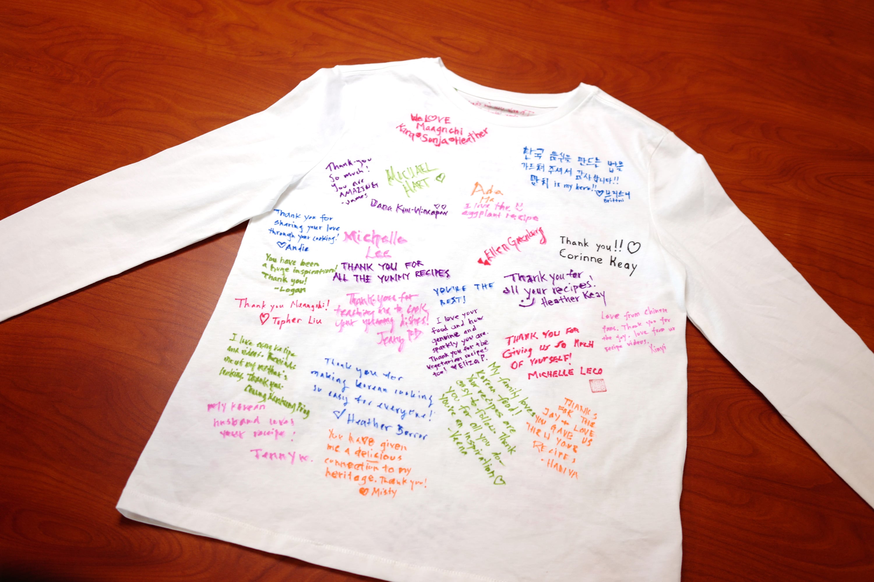 Front of a white shirt covered in colorful handwritten messages